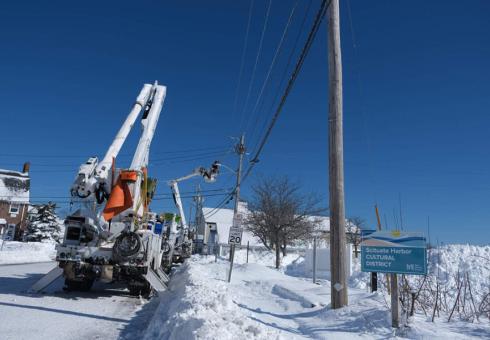 Utility workers repair a power line in Scituate. 